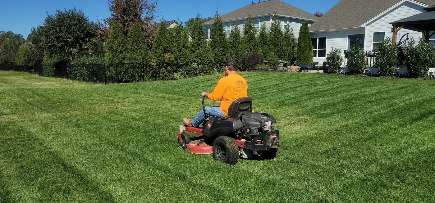 A freshly mowed lawn with clean stripes in front of a home